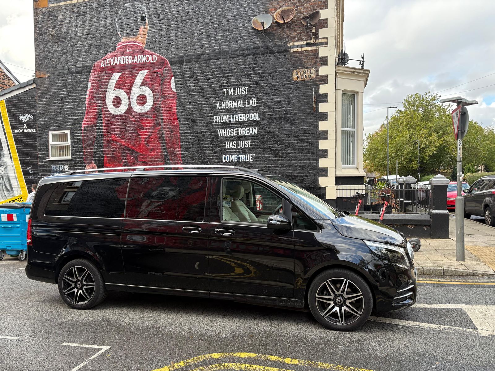 AO Platinum Chauffeurs Jet-Class beside the Trent Alexander-Arnold mural near Anfield, Liverpool